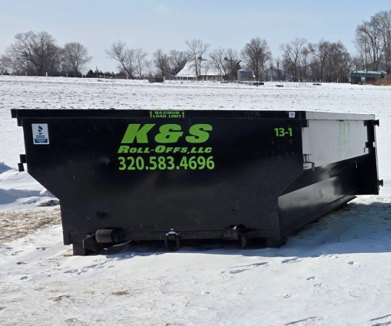k&s roll-off dumpster on a snowy lot