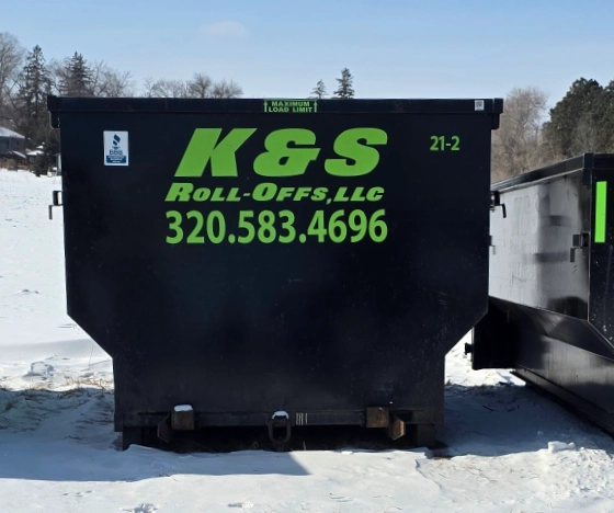 k&s roll-off dumpster on a snowy lot