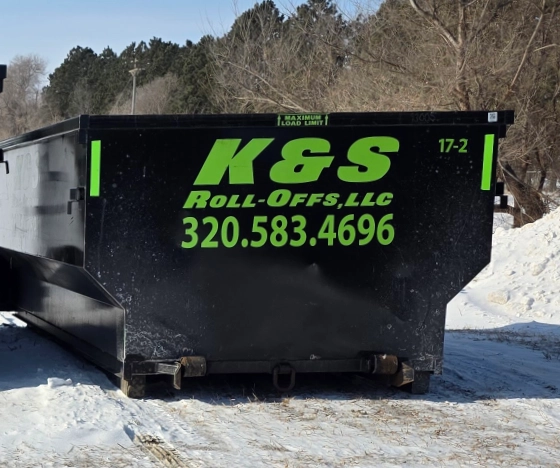 k&s roll-off dumpster on a snowy lot